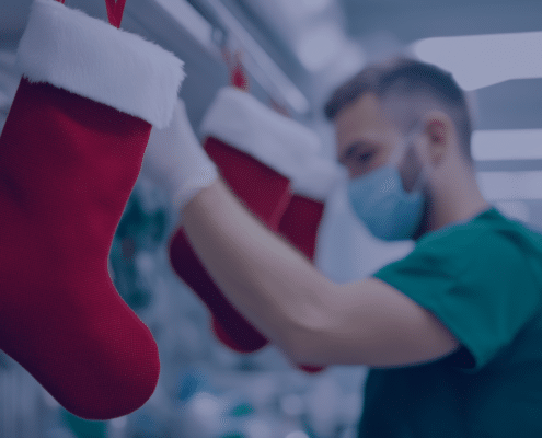 Nurse in a healthcare setting preparing holiday decorations, symbolizing strategies for managing nursing staff during the year-end healthcare rush.