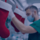 Nurse in a healthcare setting preparing holiday decorations, symbolizing strategies for managing nursing staff during the year-end healthcare rush.