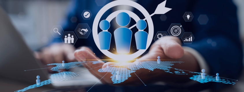 Businessperson using a tablet with recruitment and target icons hovering above, symbolizing how a recruitment agency supports H2 hiring goals