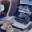 Woman using a laptop with “Job Search” on the screen while holding a coffee cup, symbolizing a mid-year career relaunch through a recruitment agency