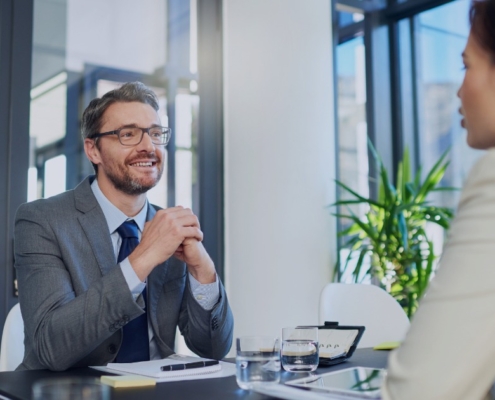Executive interview meeting in a modern office, illustrating how professional recruitment services drive executive search and hiring success.