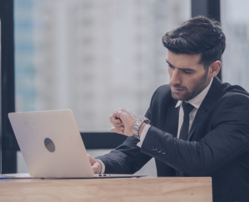 Hiring manager waiting for candidate response while recruitment services manage communication to prevent candidate ghosting.