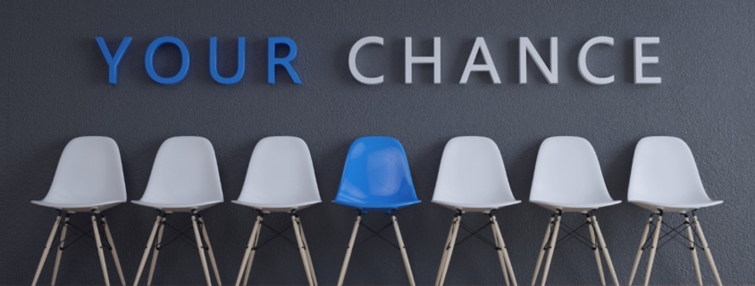 Recruitment services in Port Elizabeth helping job seekers find real opportunities in Gqeberha in 2026, shown with a blue chair standing out among white chairs.