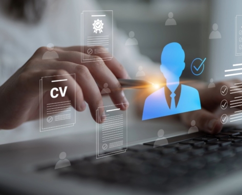 Person using a laptop with digital CV documents and candidate profile icons, representing transferable skills after job loss and new career opportunities in South Africa.